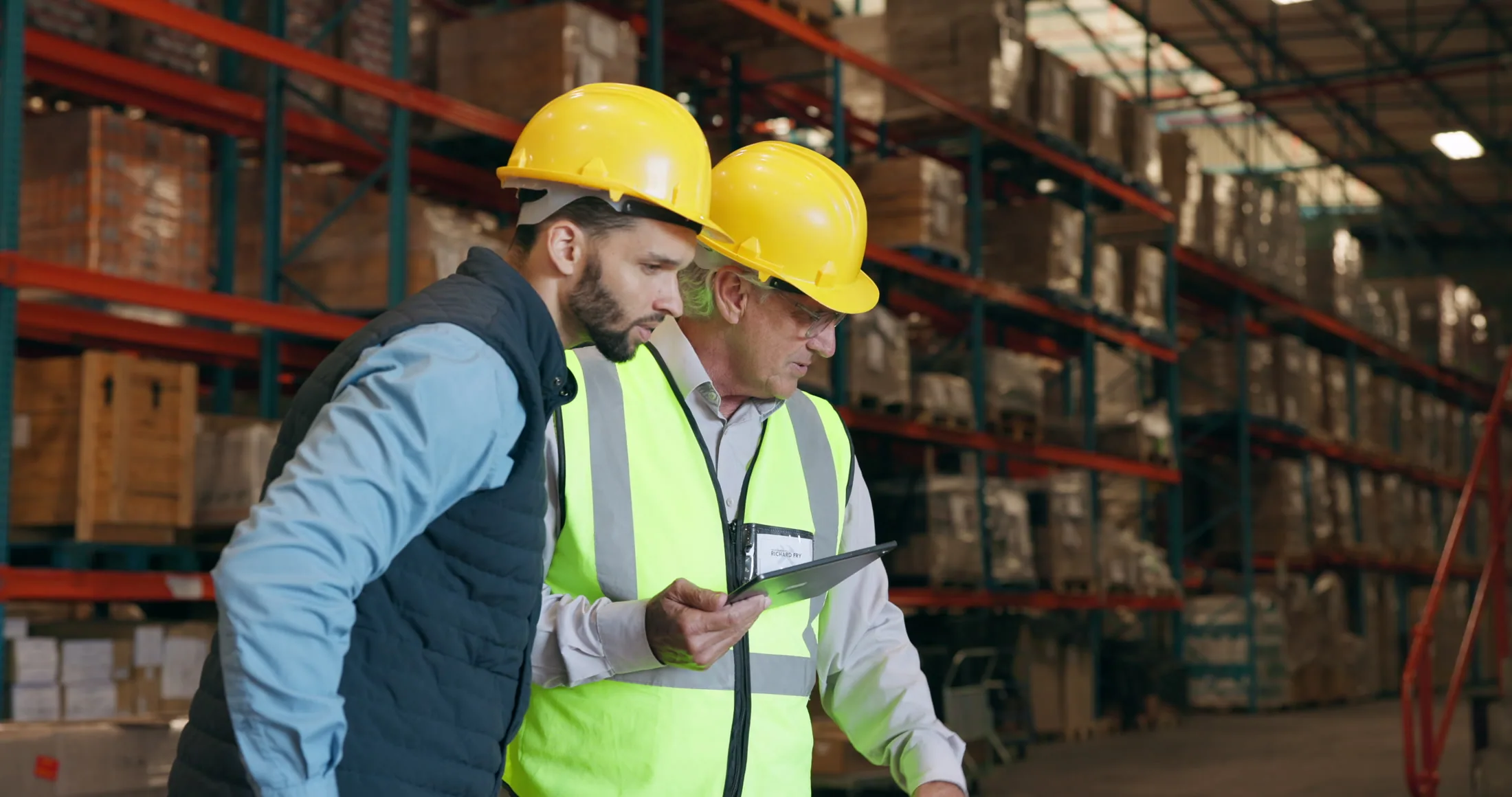 Warehouse operators reviewing fulfillment workflows on a tablet